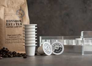 Lady filling coffee pods with ground coffee beans